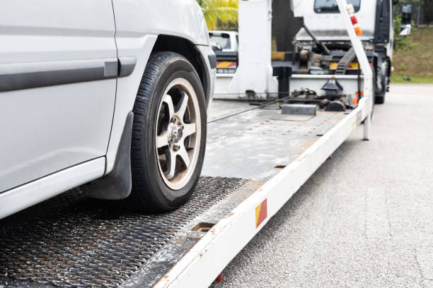 istock Cable attached to broken down car being pulled onto tow truck 1303290387