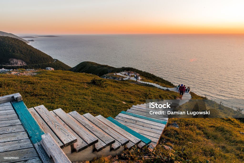 Hiking the scenic Skyline Trail, Cabot Trail at Cape Breton Highlands National Park Hiking the scenic Skyline Trail at sunset, Cabot Trail at Cape Breton Highlands National Park, Nova Scotia, Canada. Boardwalk with wooden steps at headland Nova Scotia Stock Photo