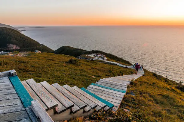 Hiking the scenic Skyline Trail at sunset, Cabot Trail at Cape Breton Highlands National Park, Nova Scotia, Canada. Boardwalk with wooden steps at headland