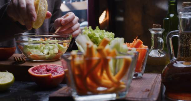 istock Preparing fresh vegetable salad with lettuce, celery, carrot, butternut and citrus fruit juices 1303291537