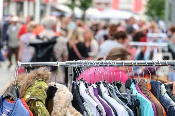 Sale: Different clothes, flea market, selective focus with very little depth of field for adequate copyspace, shopping, poverty