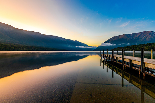 In this January 2021 long-exposure photo, Lake Rotoiti is viewed at dawn from its northern shore in Saint Arnaud, New Zealand. The lake is located within Nelson Lakes National Park.