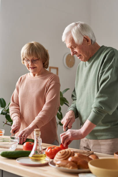 istock Senior couple cooking food 1303297606