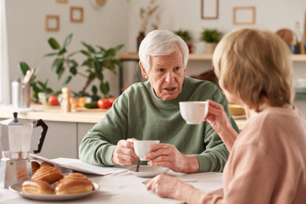 istock Senior couple having breakfast at home 1303297662