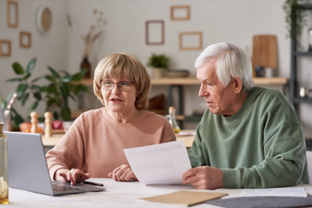 istock Senior couple paying for bills online 1303297810