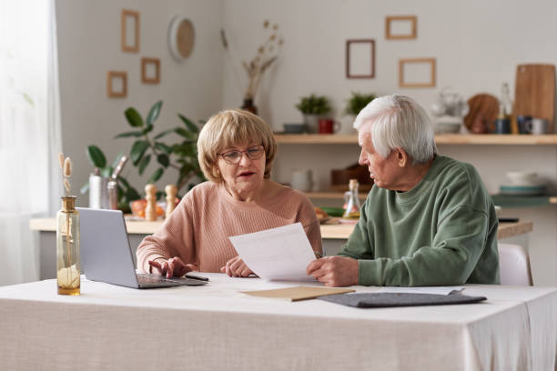 istock Senior couple working with financial documents 1303297987