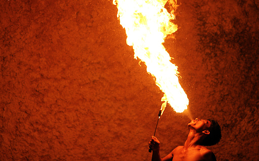 Uluwatu, Bali, Indonesia - November 22, 2012: Fire Breathing Show at Garuda Wisnu Kencana Bali