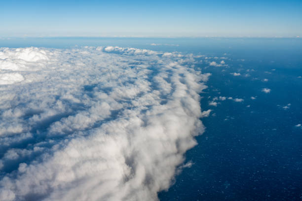 Large white cumulonimbus clouds over the ocean