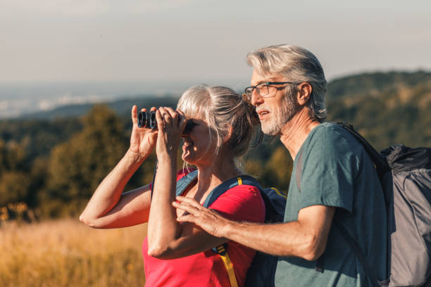 istock Active senior couple with backpacks hiking in nature. 1303306996