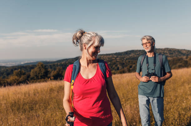 istock Active senior couple with backpacks hiking in nature. 1303307182