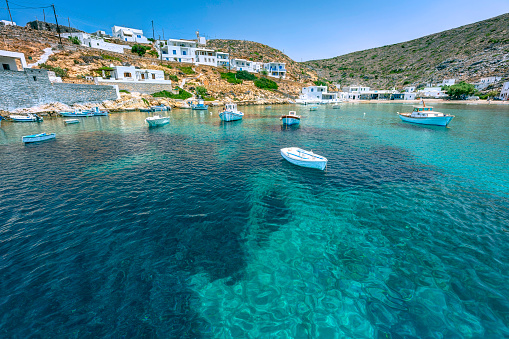 Greek culture and Travel destination: A day trip to Aegina Island, Greece, Aegean sea. Background with copy space. View from the port with sailing and fishing boats in front of town.