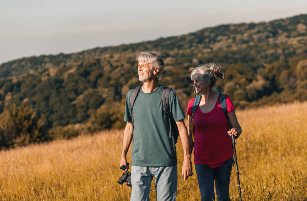 istock Active senior couple with backpacks hiking in nature. 1303307216