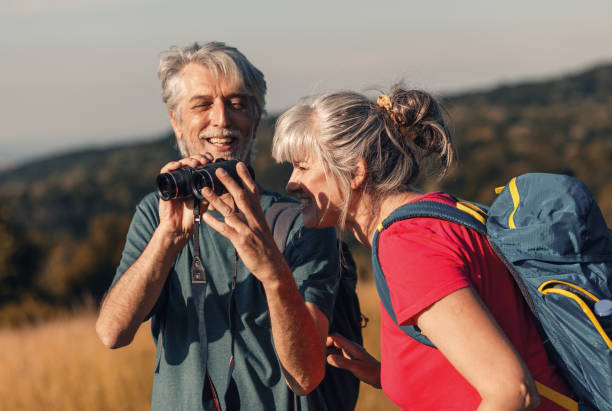 istock Active senior couple with backpacks hiking in nature. 1303307244