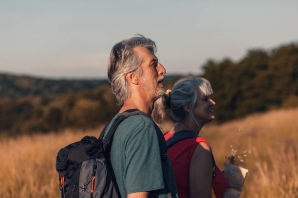 istock Active senior couple with backpacks hiking in nature. 1303307794