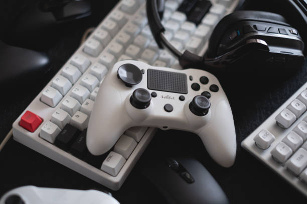 istock gamer work space concept, top view a gaming gear, mouse, keyboard, joystick and headset. 1303316806