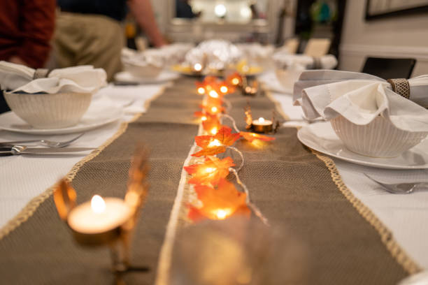 istock thanksgiving themed table setting with leaves and fairy lights 1303316998