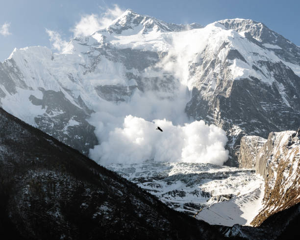Snow avalanche on Annapurna II, Annapurna Circuit Snow avalanche on Annapurna II mountain slope, Upper Pisang, Annapurna Circuit, Nepal annapurna conservation area photos stock pictures, royalty-free photos & images