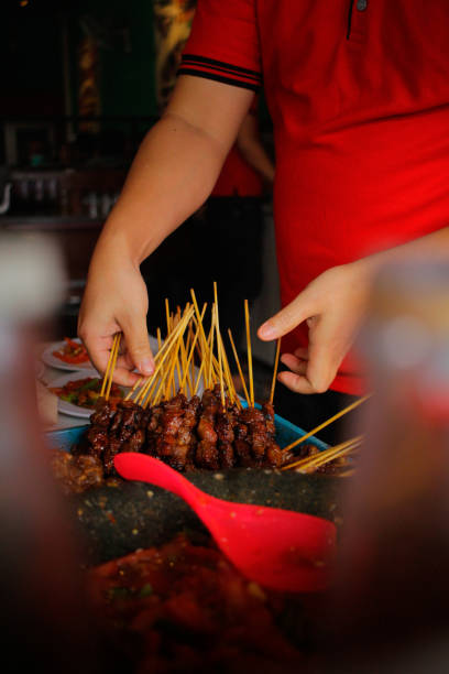 istock Someone who is preparing a satay dish for the customers 1303318396