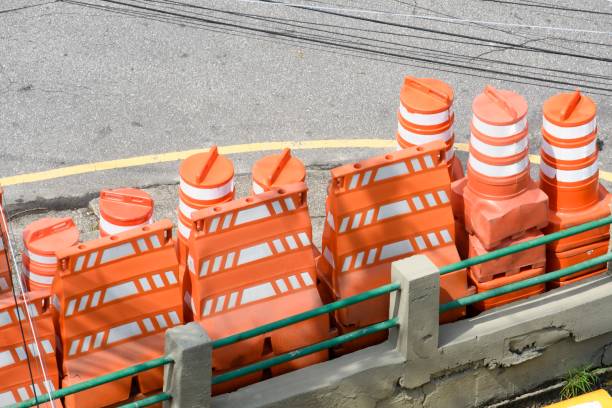 istock Stack of orange cones for traffic closure on city street 1303318711