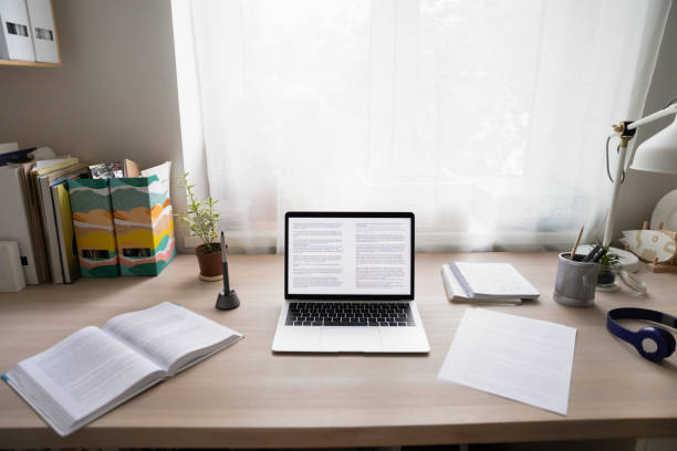 istock Cozy home office with laptop, paper documents and headphone set 1303320031