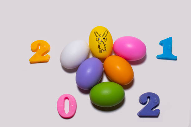 istock Easter egg  Yellow egg draw rabbit picture and number 2021 On a white background Easter day ideas 1303320212