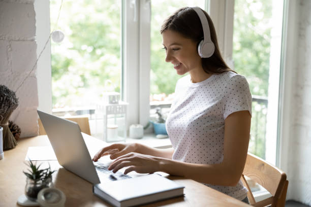 istock Millennial female studying working online using laptop and wireless headphones 1303320785