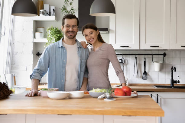 istock Loving young husband and wife posing for portrait at kitchen 1303320794