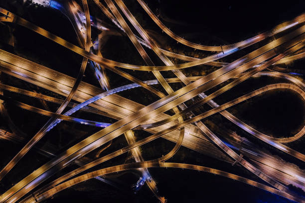 istock Aerial View of Complex Overpass and Busy Traffic at Night 1303320853