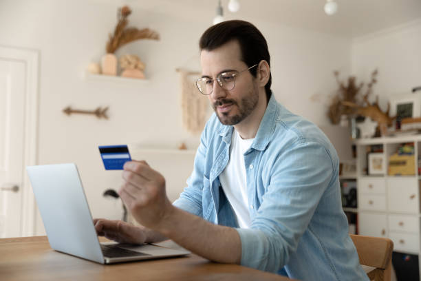 istock Attentive young businessman operating personal bank account from home computer 1303320869
