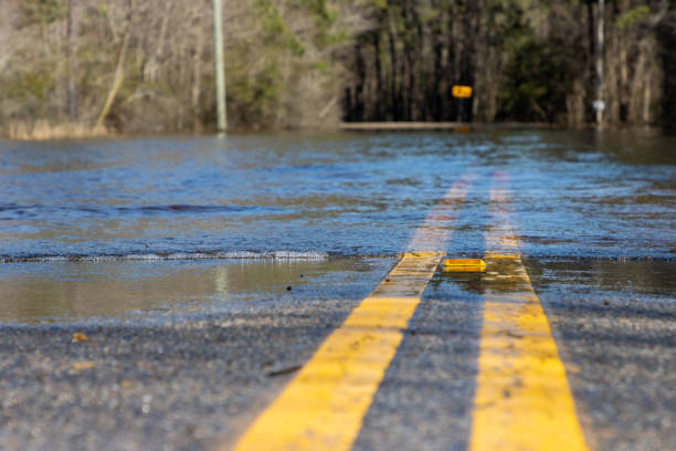 istock Water floods a rural road after heavy storm 1303322483