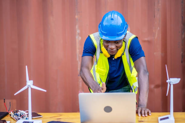 istock A male engineer using laptop, making video call to client or business partner by the negotiations were successful., On desk are windmill models. Sustainable development concept 1303323821