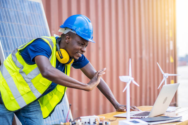 istock A male engineer using laptop, making video call to client or business partner by the negotiations were successful., On desk are windmill models. Sustainable development concept 1303323843