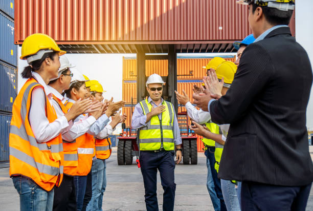 istock Professional Engineering and worker team congratulated success by applaud their jubilant leader after construction project complete with success. Engineering heavy industry concept 1303323873