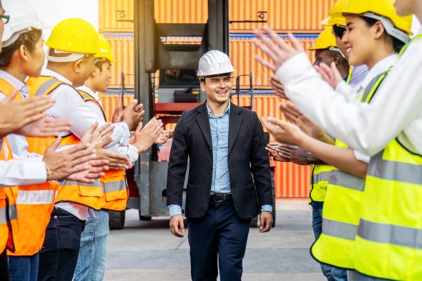 istock Professional Engineering and worker team congratulated success by applaud their jubilant leader after construction project complete with success. Engineering heavy industry concept 1303323891