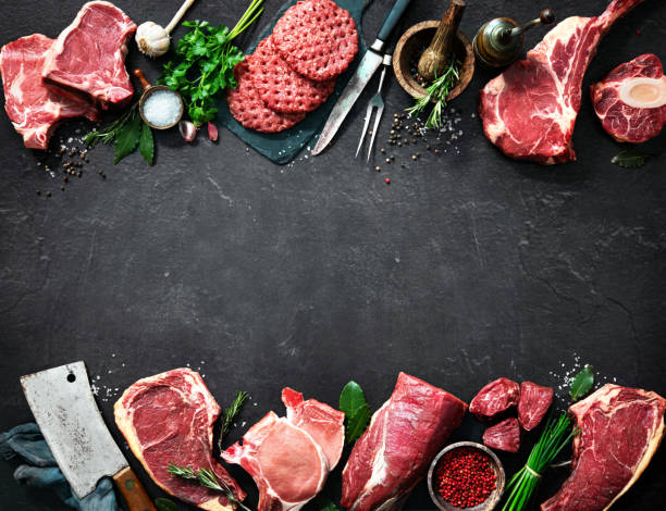 variety of raw cuts of meat, dry aged beef steaks and hamburger patties - butchers shop imagens e fotografias de stock