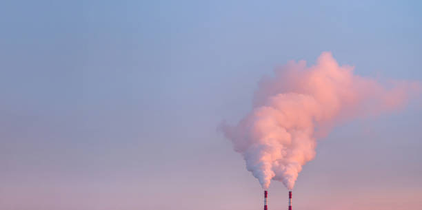 istock Factory pipes with smoke, frost, sunrise, copy space 1303324943