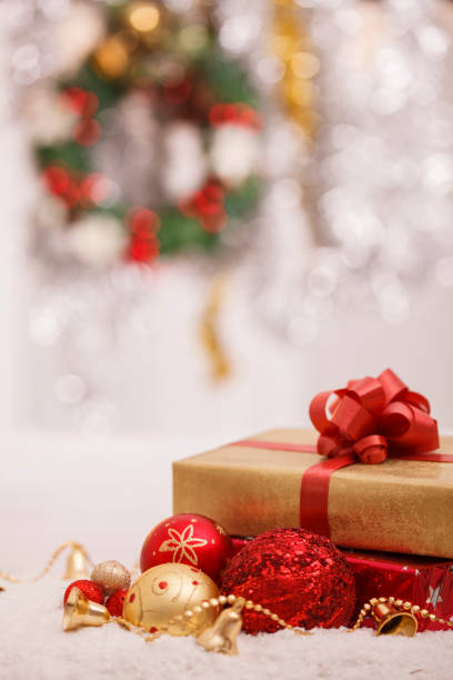 istock Nice Christmas background with a present, ornaments and a wreath 1303325900