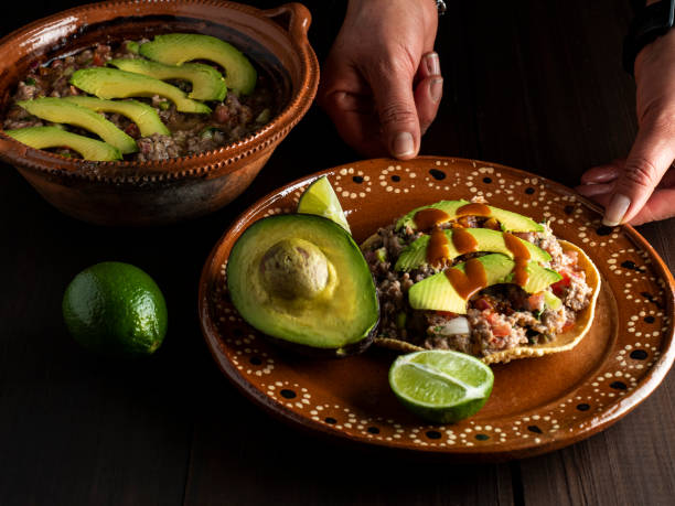 Meat cooked with lemon and mixed with vegetables, tomato, onion, coriander and avocado. Mexican food.