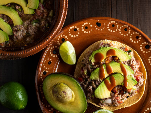 Meat cooked with lemon and mixed with vegetables, tomato, onion, coriander and avocado. Mexican food.