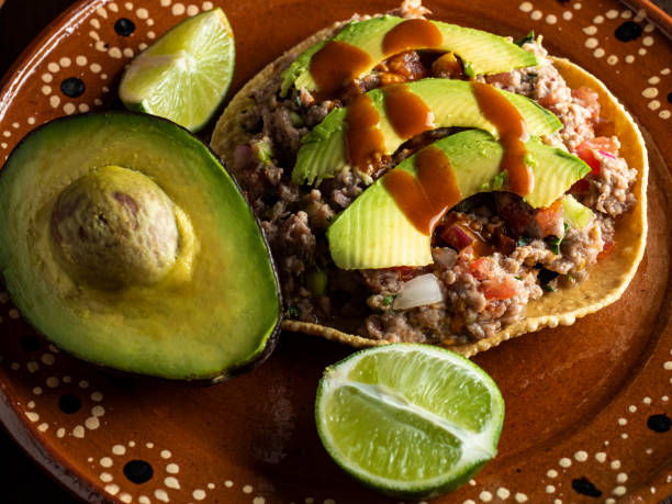 Meat cooked with lemon and mixed with vegetables, tomato, onion, coriander and avocado. Mexican food.