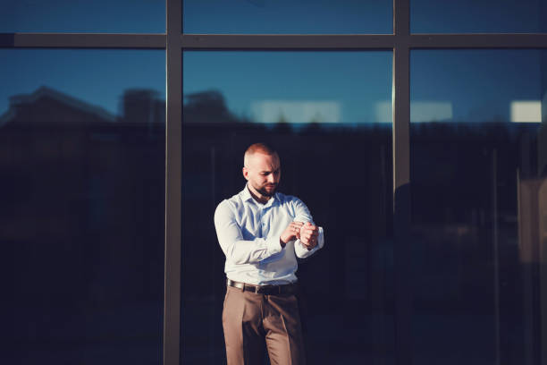 istock Handsome young businessman adjusting his sleeves 1303328411