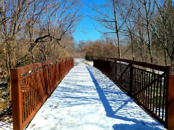 istock Bridge over creek on trail covered with snow 1303331528