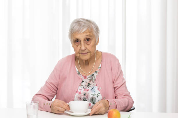 istock Senior woman enjoying meal 1303331661