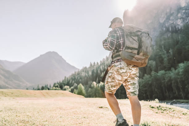 istock hiker man walking in the mountains 1303332918