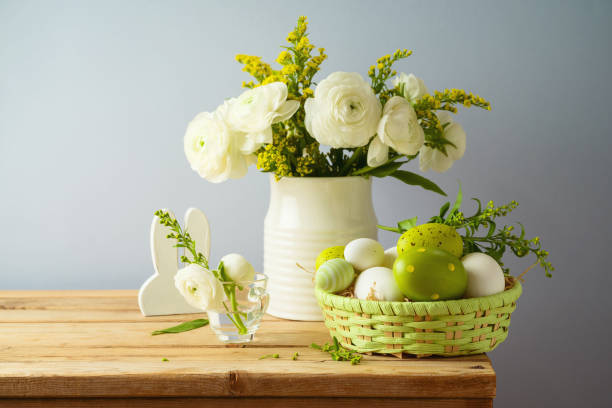 istock Easter holiday concept with beautiful flowers bouquet and Easter eggs on wooden table 1303335307