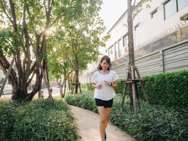 istock Woman running in park 1303336414