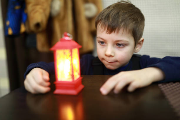 istock Child looking at small lamp 1303337819