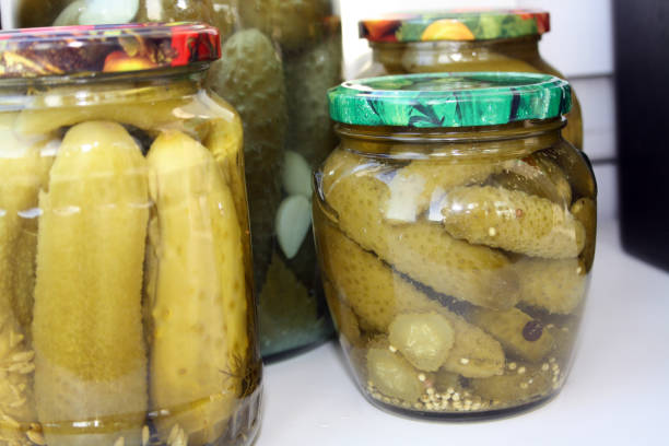istock Jar of pickled cucumbers on a black background. 1303342726