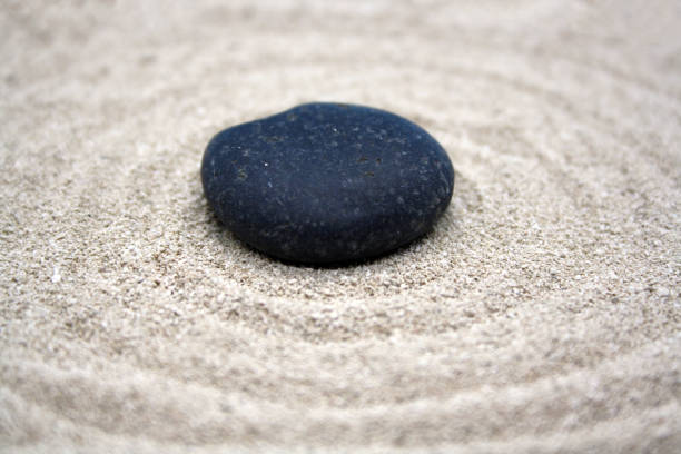 istock Sea round stones on the fine sand. Selective focus. 1303342780