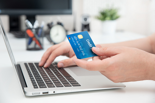 Credit card in hand. Online shopping, e-commerce concept